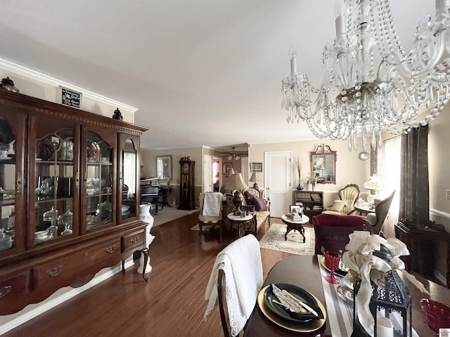 dining room featuring ceiling fan with notable chandelier and dark wood-type flooring