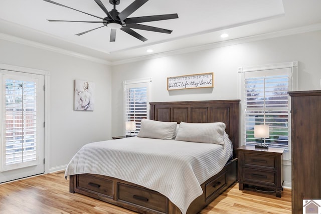 bedroom with multiple windows, ceiling fan, and access to exterior