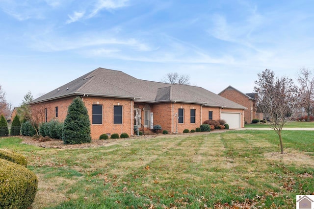 view of side of property with a yard and a garage