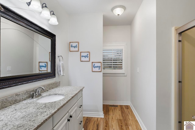 bathroom featuring hardwood / wood-style floors and vanity