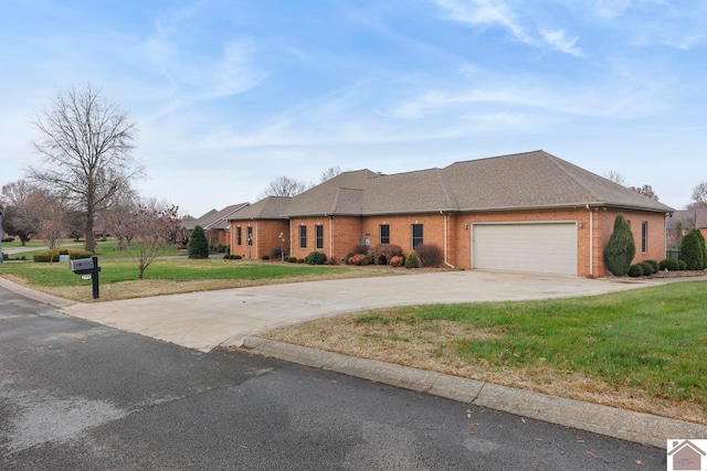 view of front of house featuring a garage and a front lawn