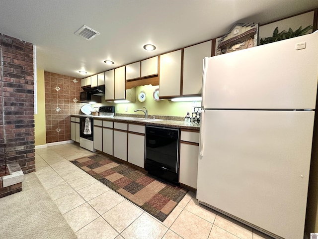 kitchen featuring white cabinets, light tile patterned floors, white appliances, and sink