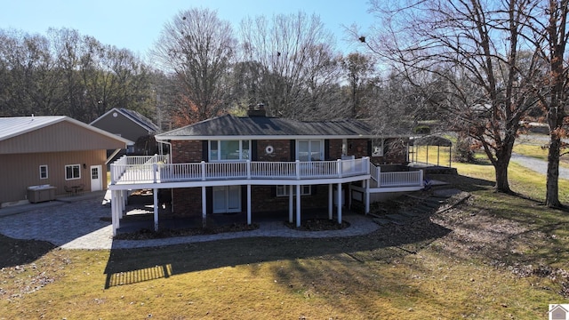 back of house featuring a deck and a yard