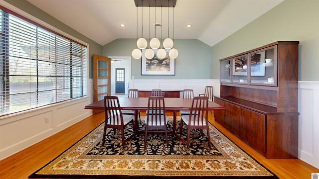 dining room featuring light hardwood / wood-style floors and vaulted ceiling