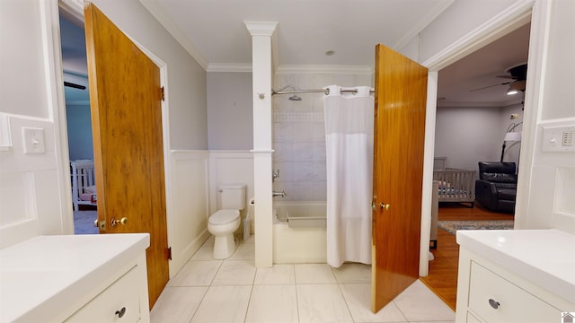 full bathroom featuring ceiling fan, shower / bathtub combination with curtain, crown molding, toilet, and vanity