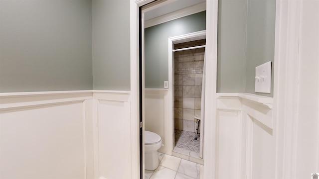 bathroom with tile patterned flooring and toilet