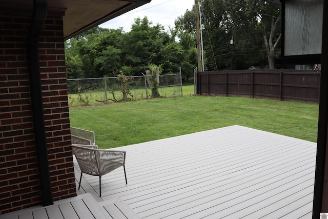 wooden deck with a lawn