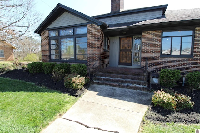 doorway to property with a yard