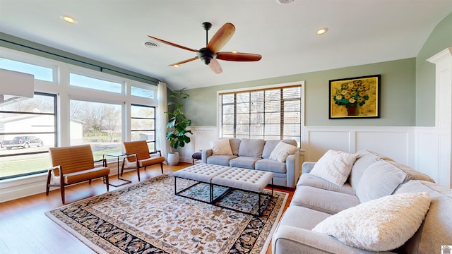 living room featuring ceiling fan, plenty of natural light, hardwood / wood-style floors, and vaulted ceiling