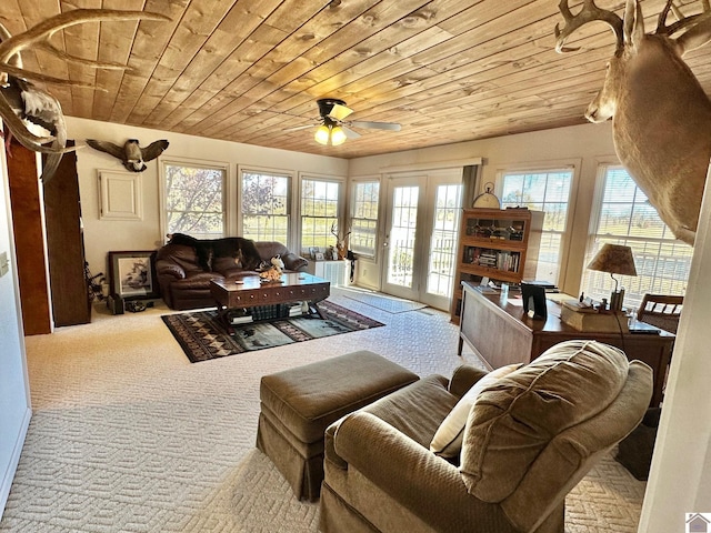 carpeted living room with ceiling fan and wooden ceiling