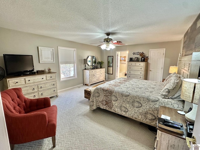 carpeted bedroom featuring ceiling fan and a textured ceiling