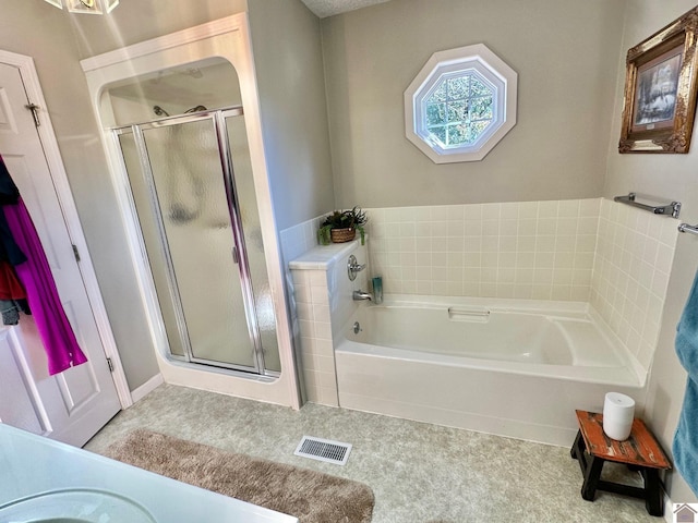 bathroom with separate shower and tub