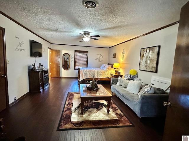 bedroom featuring ceiling fan, dark hardwood / wood-style flooring, a textured ceiling, and ornamental molding