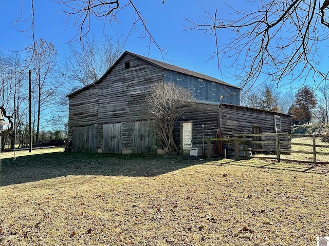 view of home's exterior featuring an outbuilding and a lawn