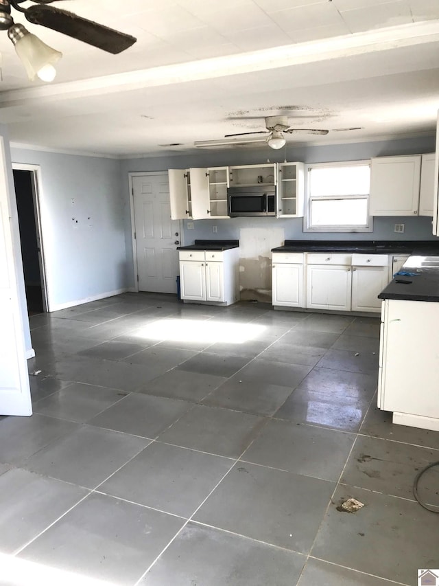 kitchen with white cabinetry and dark tile patterned flooring