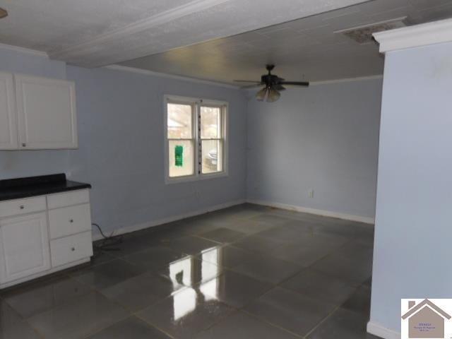 82 Ingleside Rd, Kevil, KY 42053 - unfurnished dining area with ceiling fan, ornamental molding, and dark tile patterned flooring