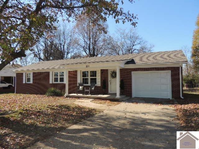 ranch-style house featuring a porch and a garage