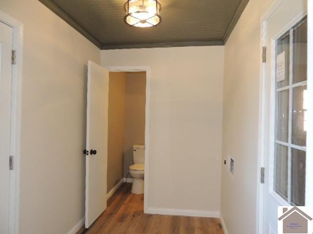 hall with crown molding and dark hardwood / wood-style floors