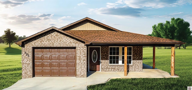 view of front of property with a front yard and a garage