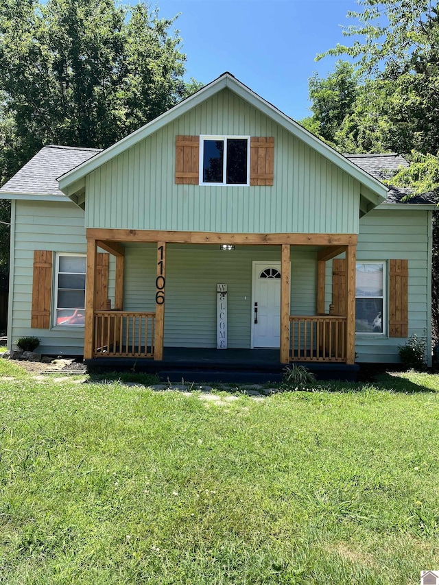 view of front of house with covered porch and a front yard