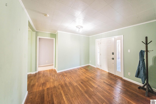 foyer entrance featuring ornamental molding and dark wood-type flooring