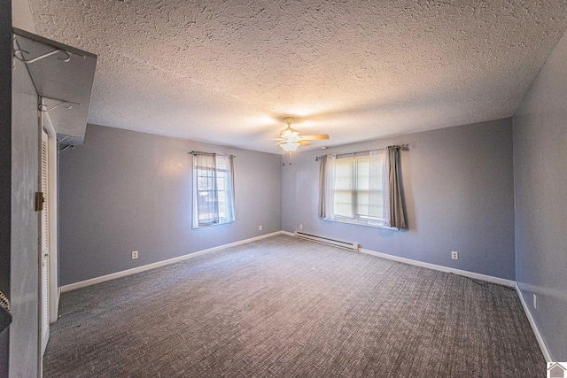 empty room with ceiling fan, carpet, a textured ceiling, and a baseboard heating unit