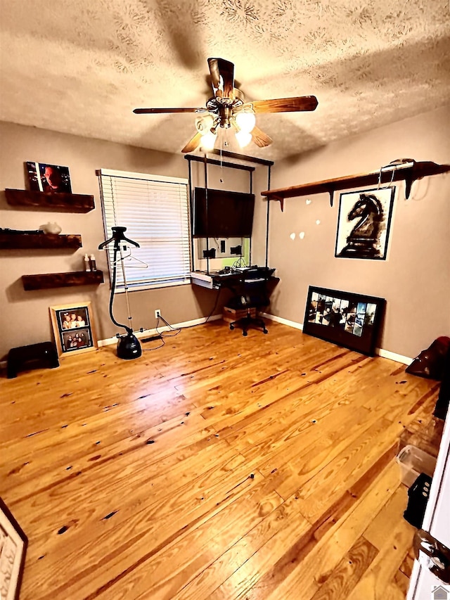 office space with ceiling fan, wood-type flooring, and a textured ceiling