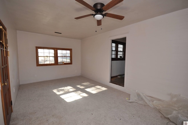 empty room featuring light colored carpet and ceiling fan