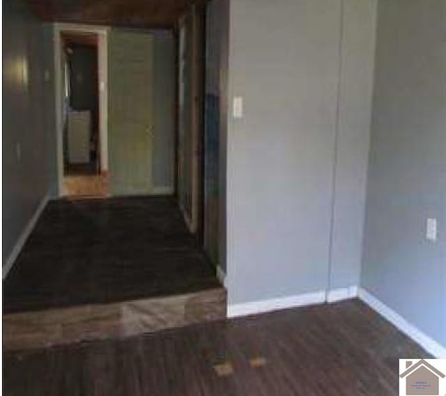 corridor with dark hardwood / wood-style floors