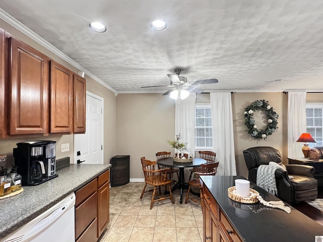 kitchen with dishwasher, a healthy amount of sunlight, light tile patterned floors, and crown molding