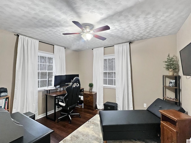 office featuring dark hardwood / wood-style floors, ceiling fan, and a textured ceiling