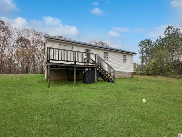 back of property with a lawn and a wooden deck