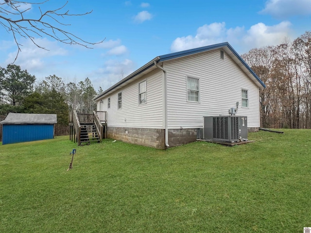 view of side of property featuring central AC unit, a shed, and a lawn