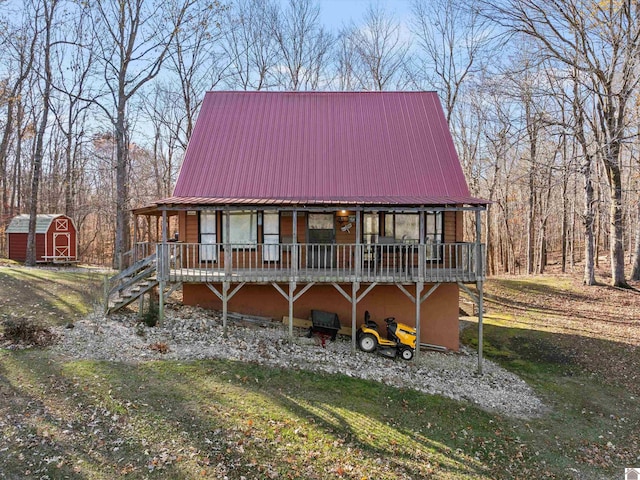 view of front facade with a front yard and a shed