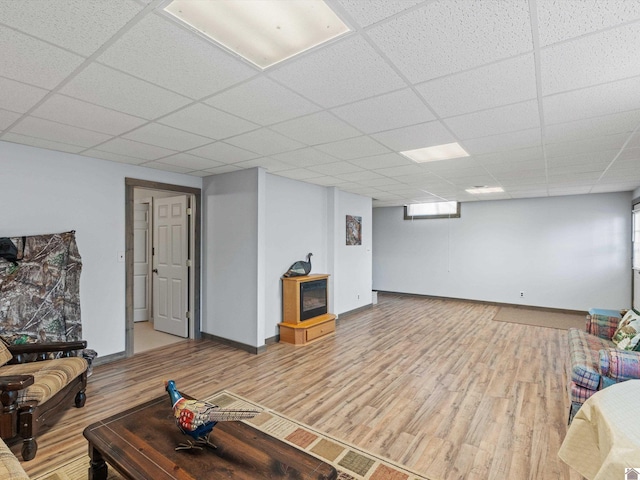 living room with wood-type flooring and a drop ceiling