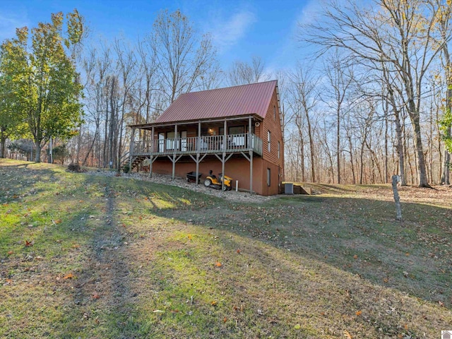 view of front of house with a front yard and a deck