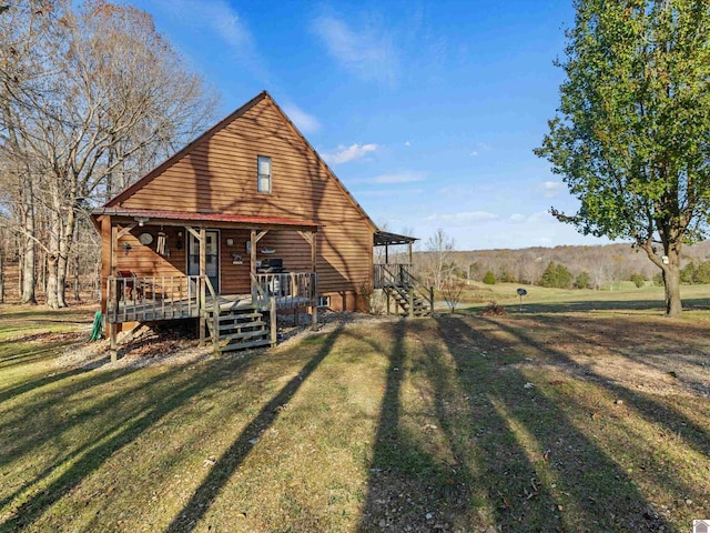 back of property with a porch and a yard