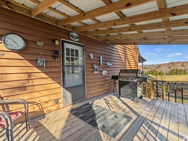 wooden deck with area for grilling and a mountain view