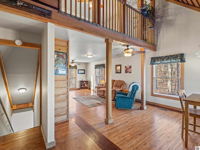 living room with hardwood / wood-style flooring and ornate columns