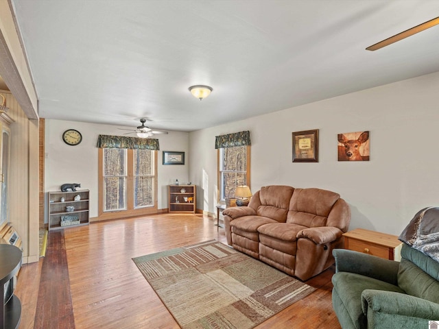 living room with hardwood / wood-style flooring and ceiling fan