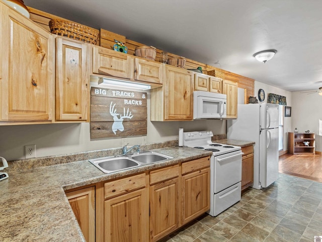 kitchen featuring light brown cabinetry, white appliances, ceiling fan, sink, and wood-type flooring