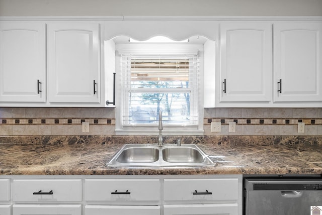 kitchen featuring backsplash, white cabinetry, stainless steel dishwasher, and sink