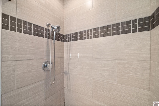 interior details with a tile shower