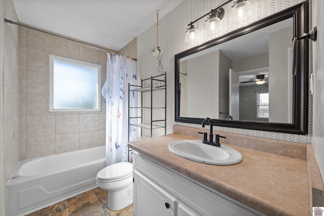 full bathroom featuring ceiling fan, toilet, shower / bath combo with shower curtain, and vanity