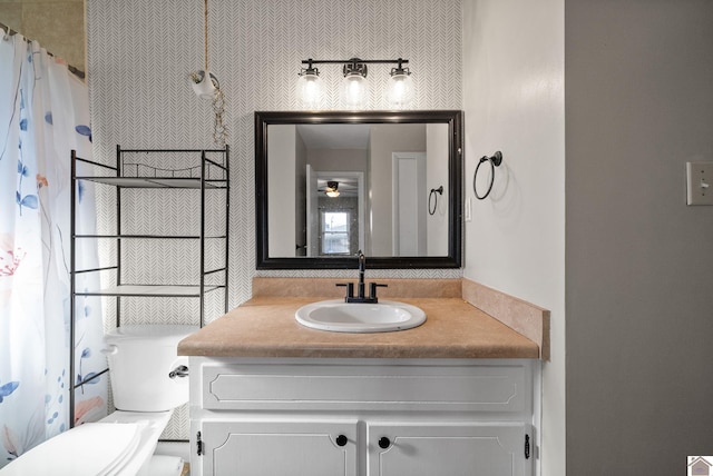 bathroom with vanity, a shower with shower curtain, and toilet