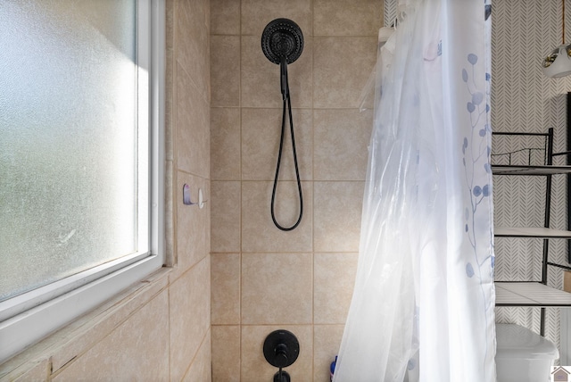 bathroom featuring curtained shower and toilet