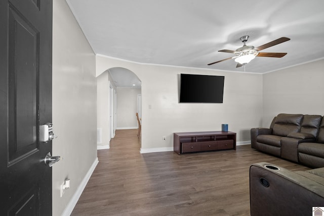 living room featuring crown molding, ceiling fan, and hardwood / wood-style flooring