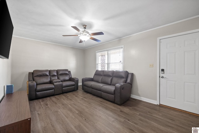 living room with hardwood / wood-style floors, ceiling fan, and crown molding