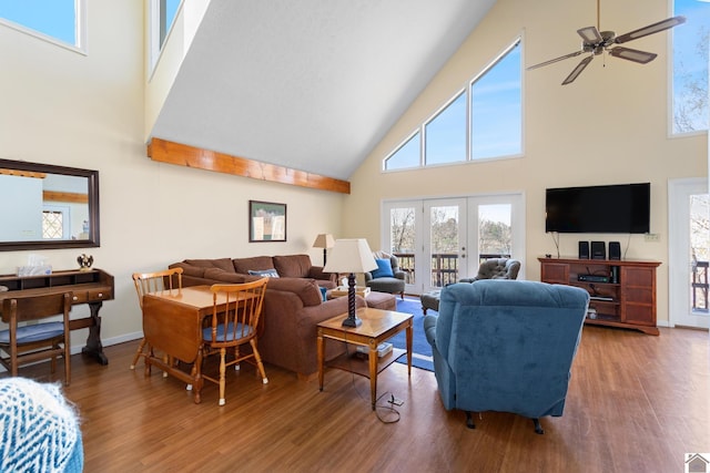 living room featuring wood-type flooring, high vaulted ceiling, and ceiling fan