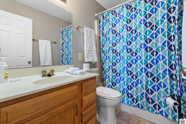 bathroom with a shower with shower curtain, vanity, toilet, and a textured ceiling